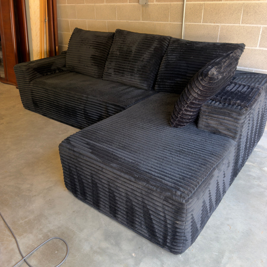 Black oversized corduroy sectional with chaise - three-quarter view
