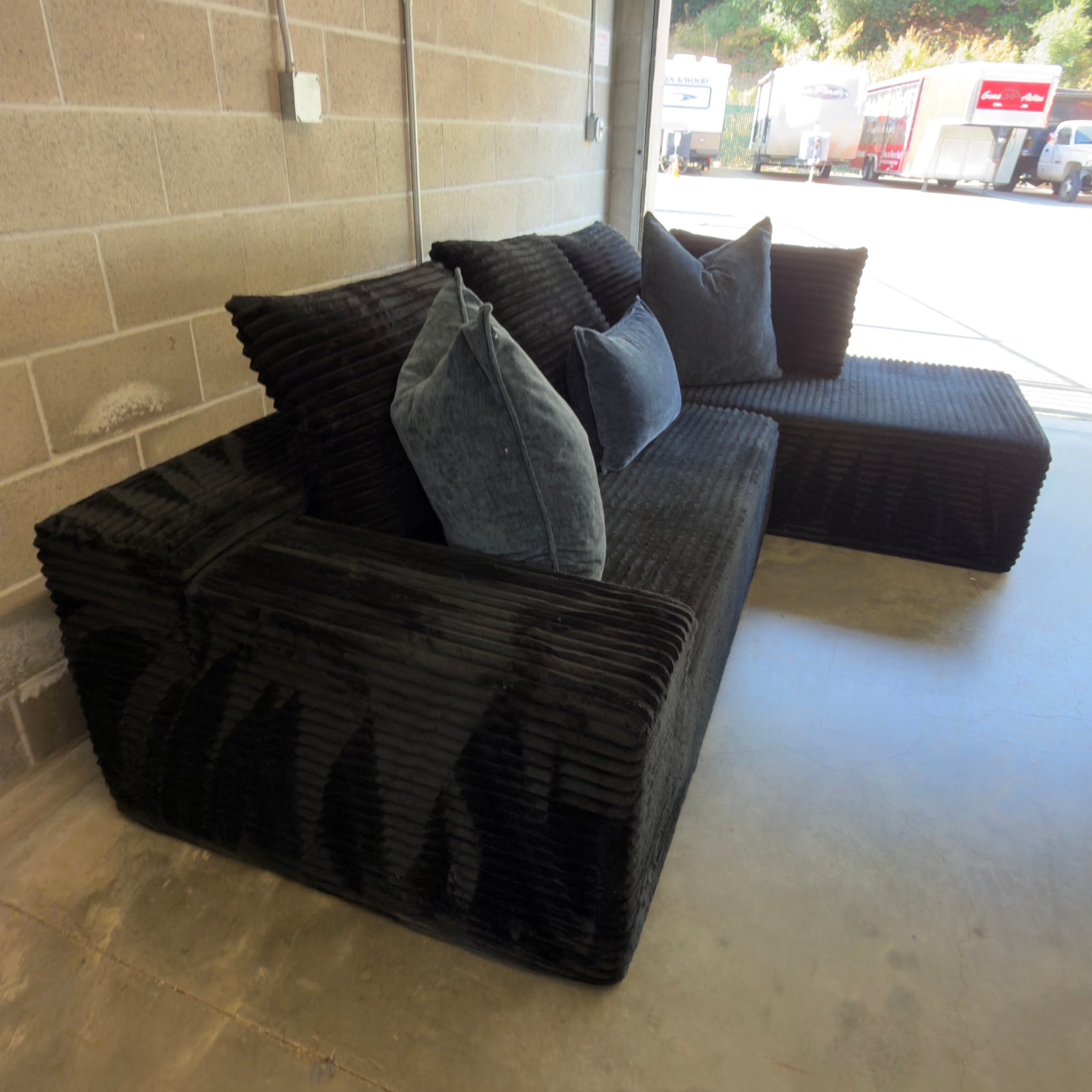 Black corduroy sectional - rear three-quarter view