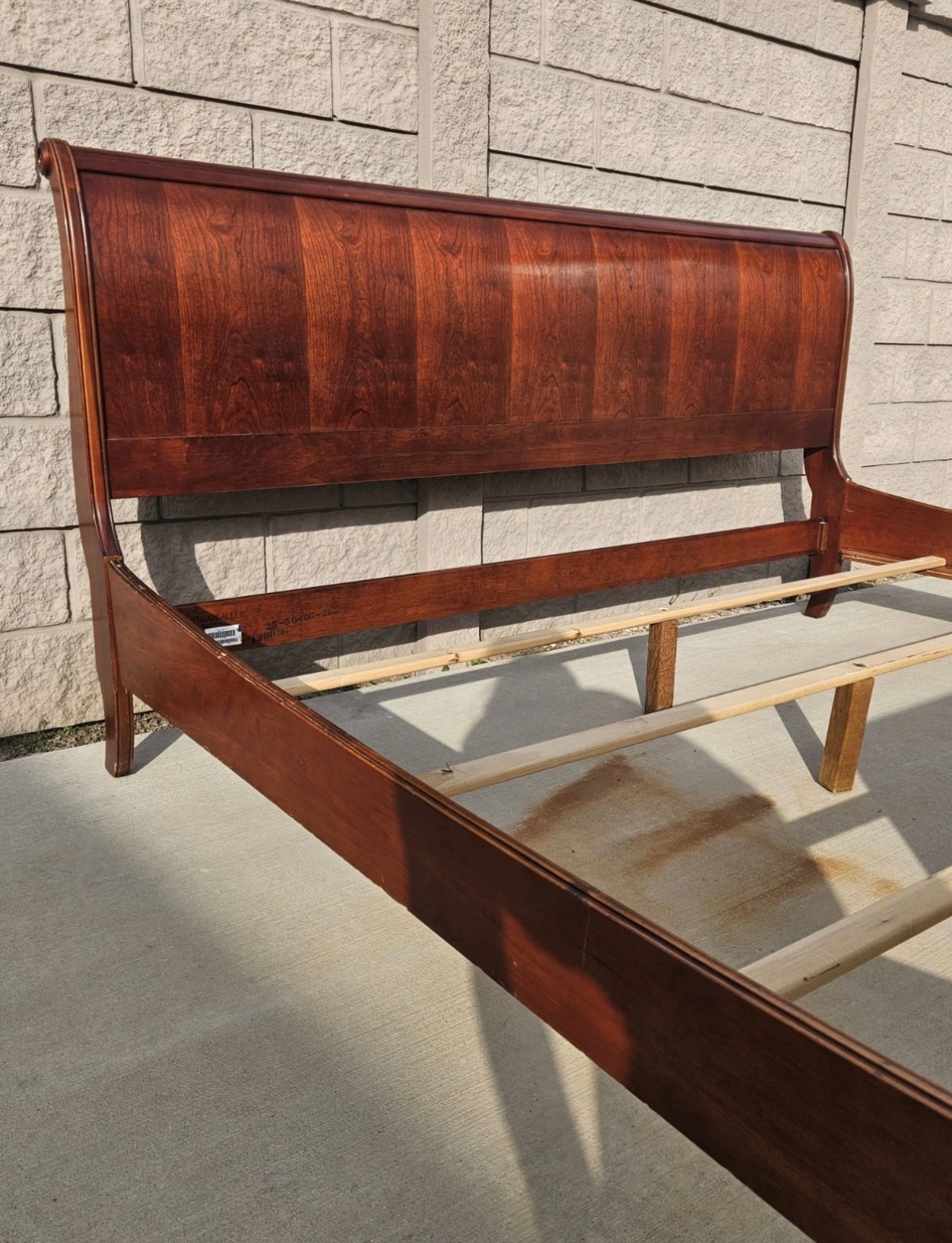 Ethan Allen sleigh bed - close-up of scratch in cherry finish