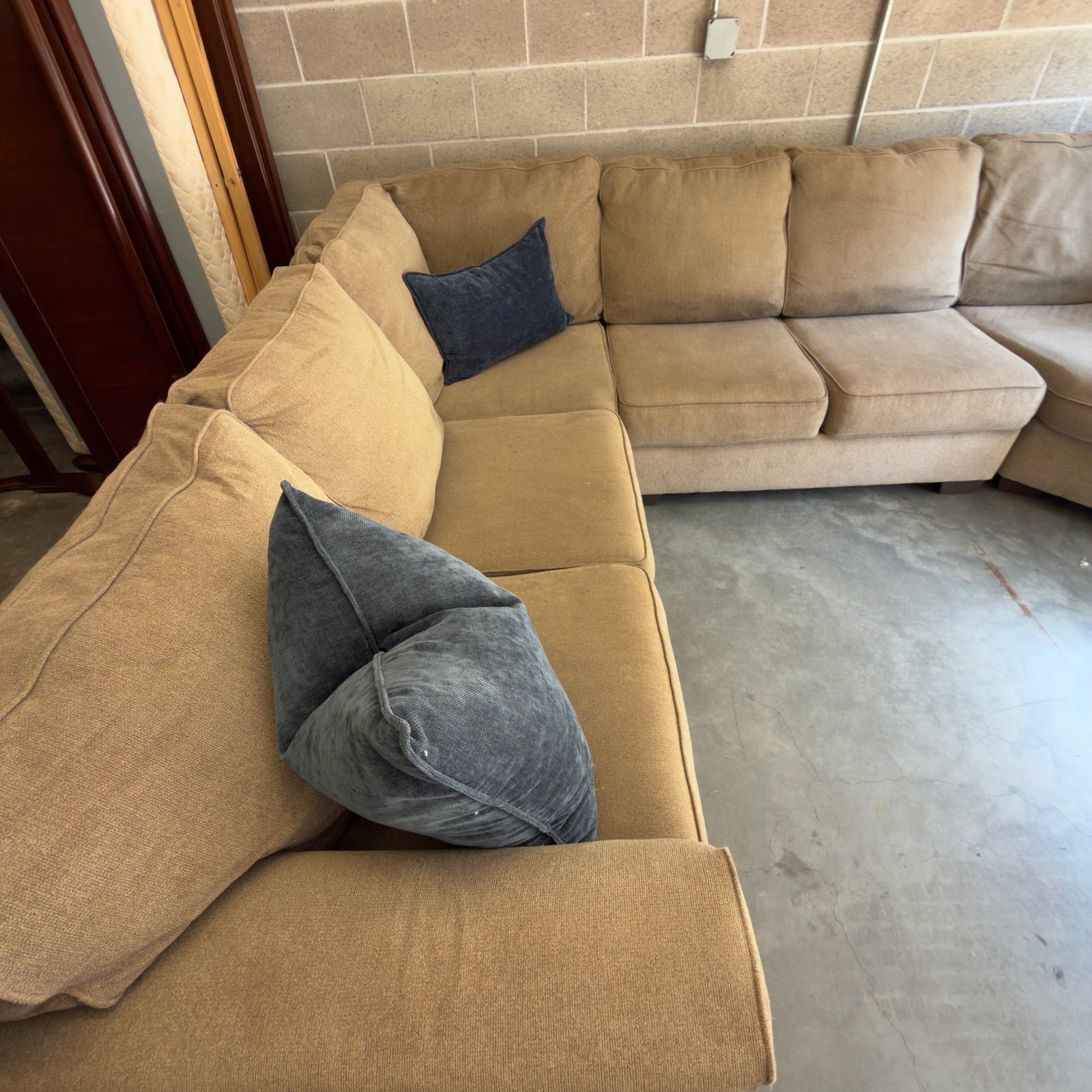 Tan fabric sectional sofa, full view from opposite corner