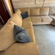 Tan fabric sectional sofa, full view from opposite corner