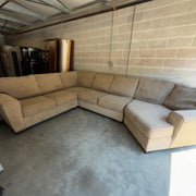 Tan fabric sectional sofa, angled view of the long run