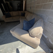 Tan fabric sectional sofa, full length view with accent pillows
