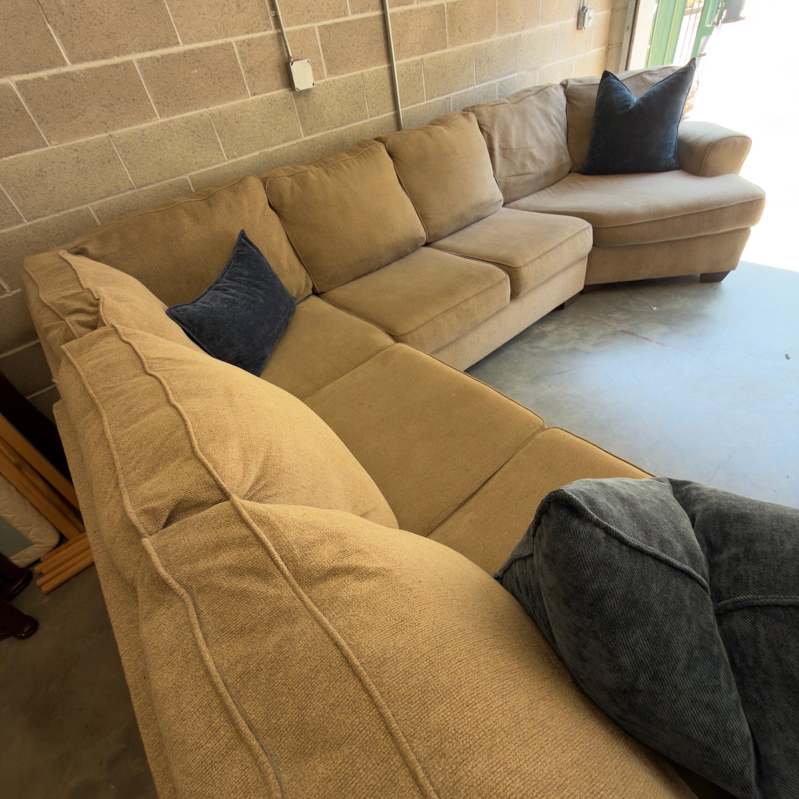 Tan fabric sectional sofa, overhead view of the corner cushions