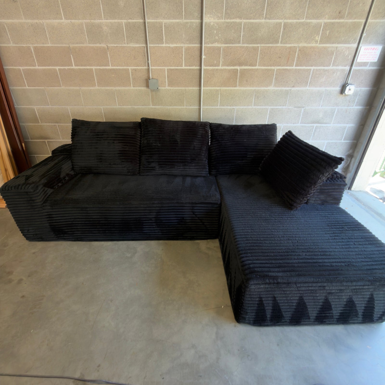 Black ribbed corduroy sectional - full front view