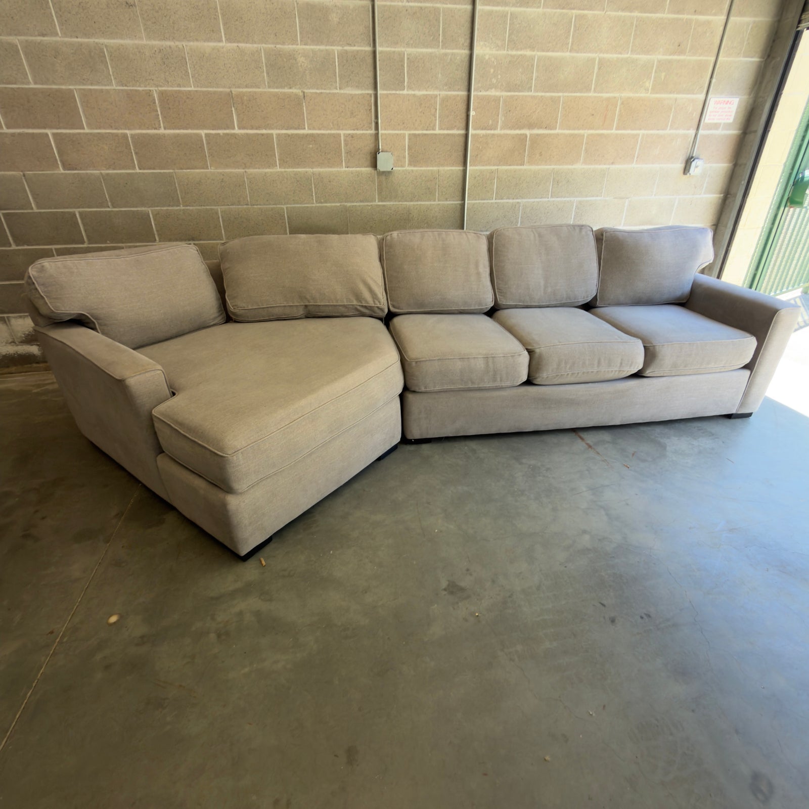 Used gray two-piece sectional couch with chaise by Living Spaces, for sale at Couch Potato Furniture in Hayward, California