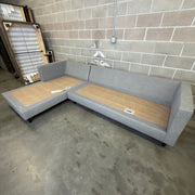 Gray Living Spaces Calais III sectional sofa frame without cushions, showing legs and construction