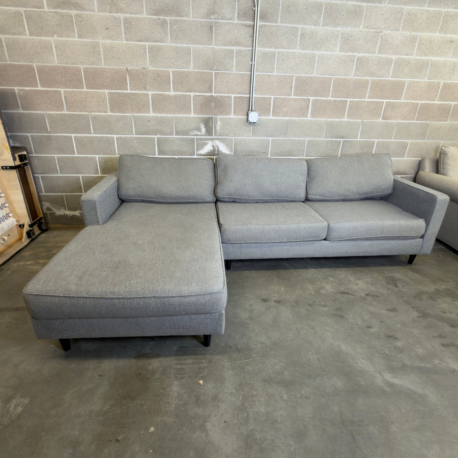 Used gray Living Spaces Calais III sectional sofa with chaise, for sale at Couch Potato Furniture in Hayward, California