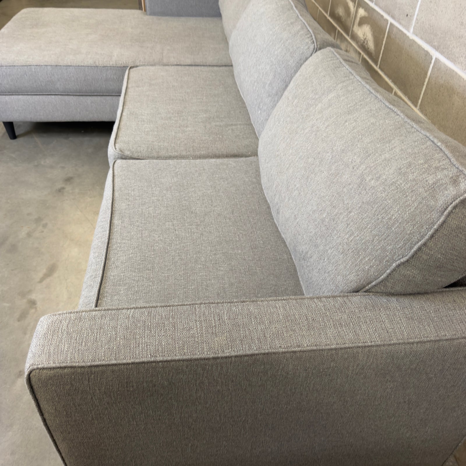 Close-up of gray upholstery fabric texture on the Living Spaces Calais III sectional sofa