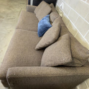 Brown Crate & Barrel tweed sofa, top-down cushion detail