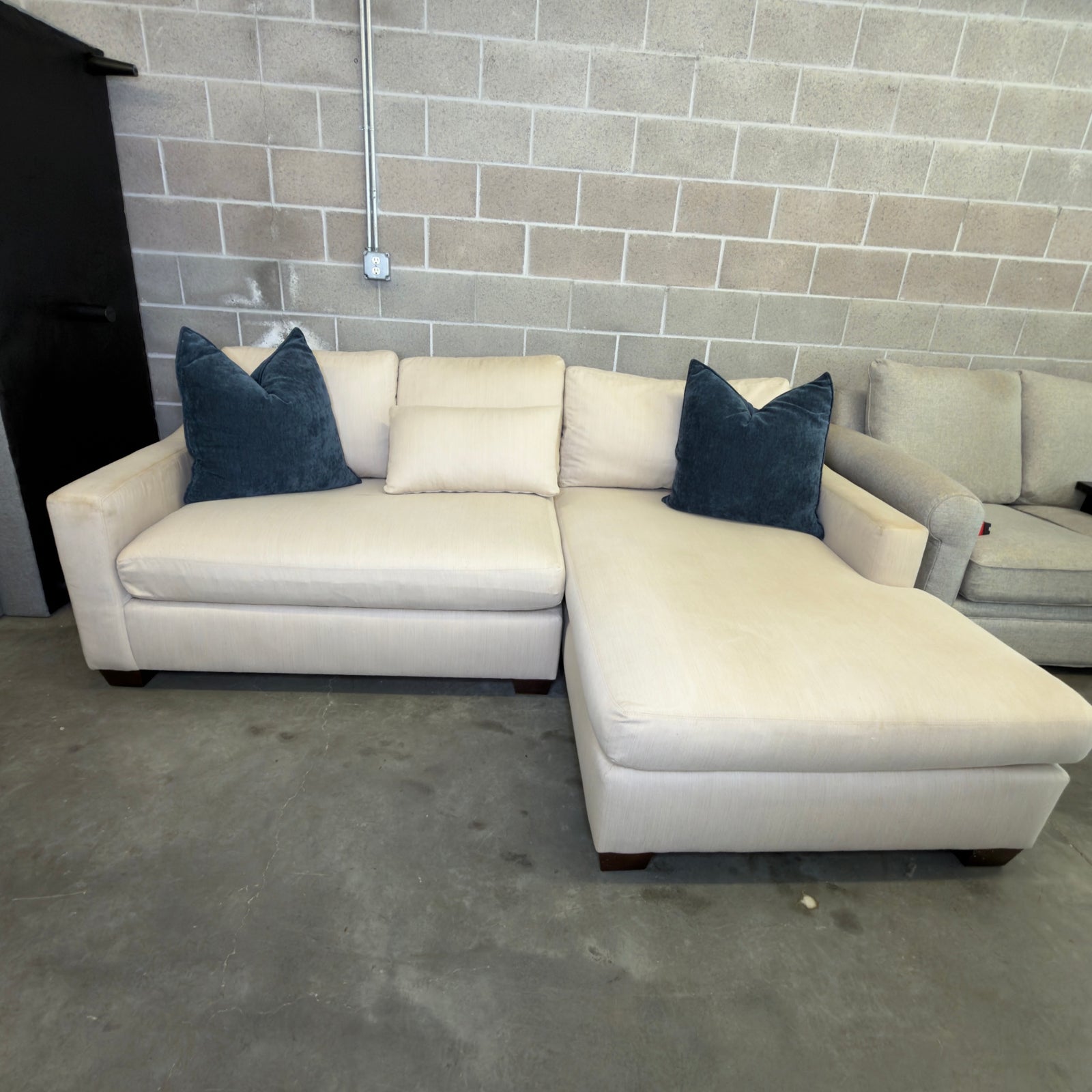 Oatmeal Pottery Barn York chaise loveseat styled with navy accent pillows