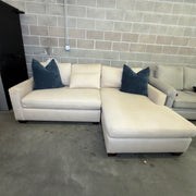 Oatmeal Pottery Barn York chaise loveseat styled with navy accent pillows