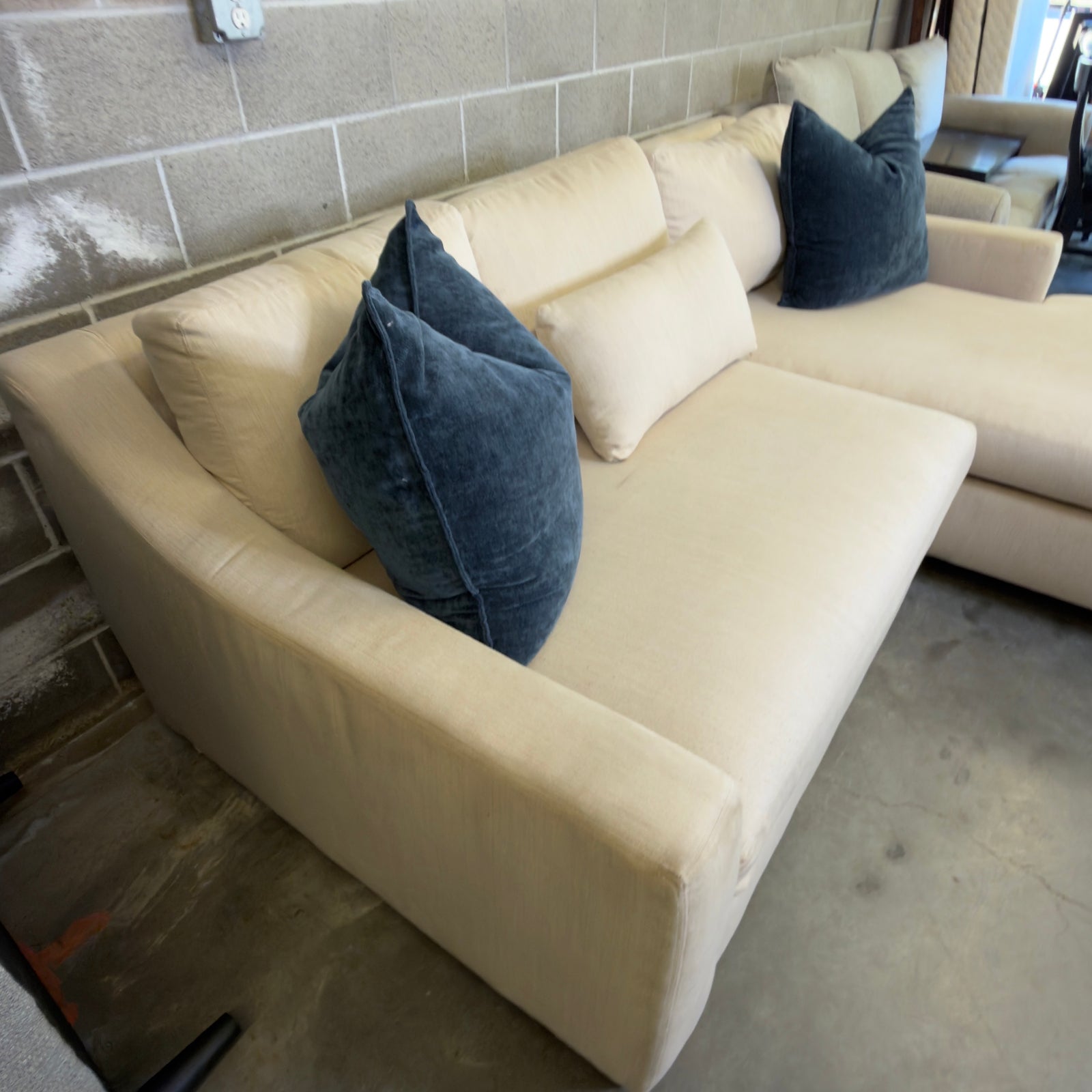 Oatmeal Pottery Barn York chaise loveseat, side view in warehouse