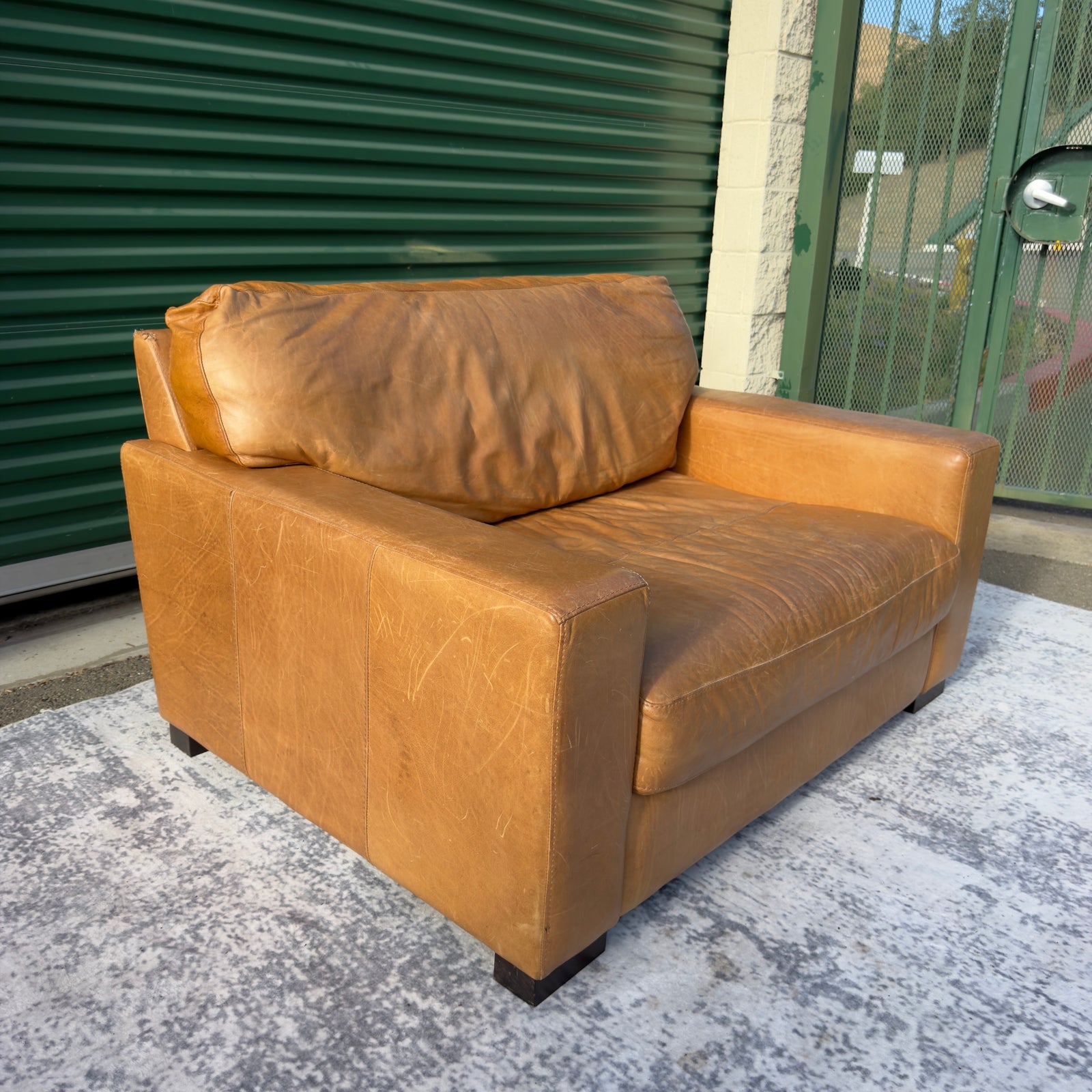 Cognac leather oversized club chair, three-quarter angle view