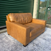 Cognac leather oversized club chair, three-quarter angle view