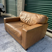 Cognac leather oversized club chair, close-up view of repaired seam corner