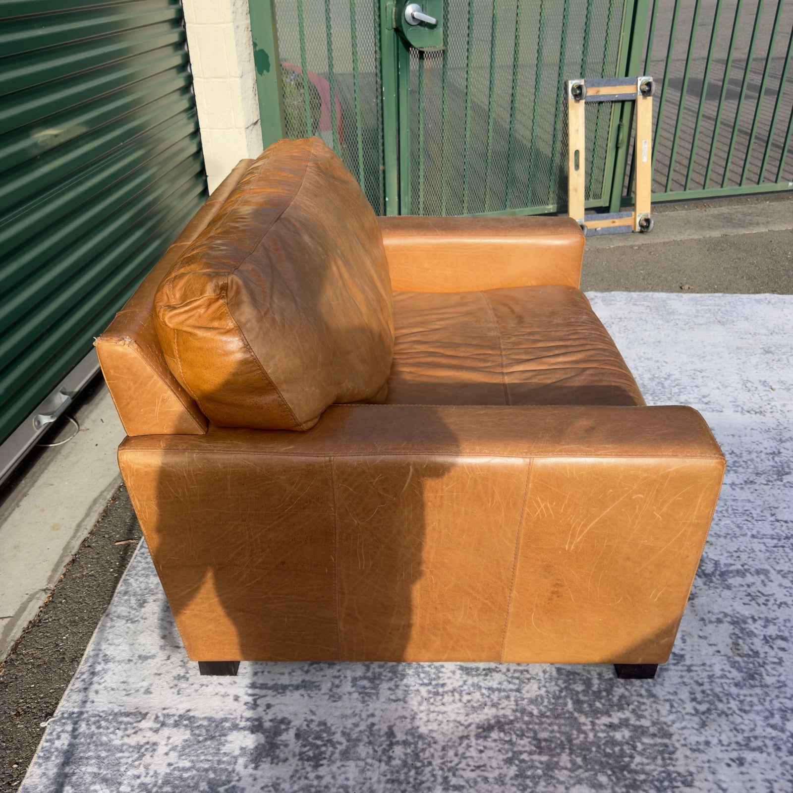 Cognac leather oversized club chair, side view