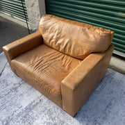 Cognac leather oversized club chair, angled view showing seat cushion
