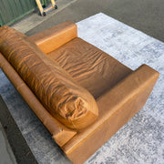 Cognac leather oversized club chair, top-down view showing back cushion wear