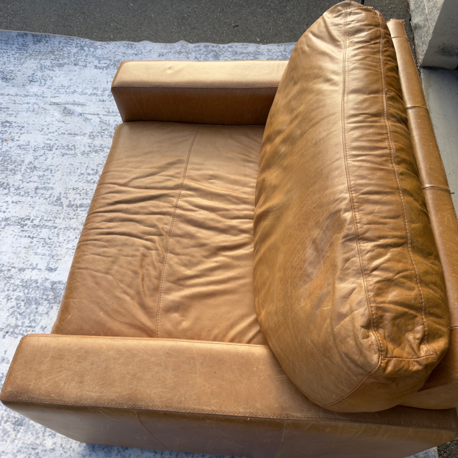 Cognac leather oversized club chair, top-down cushion detail